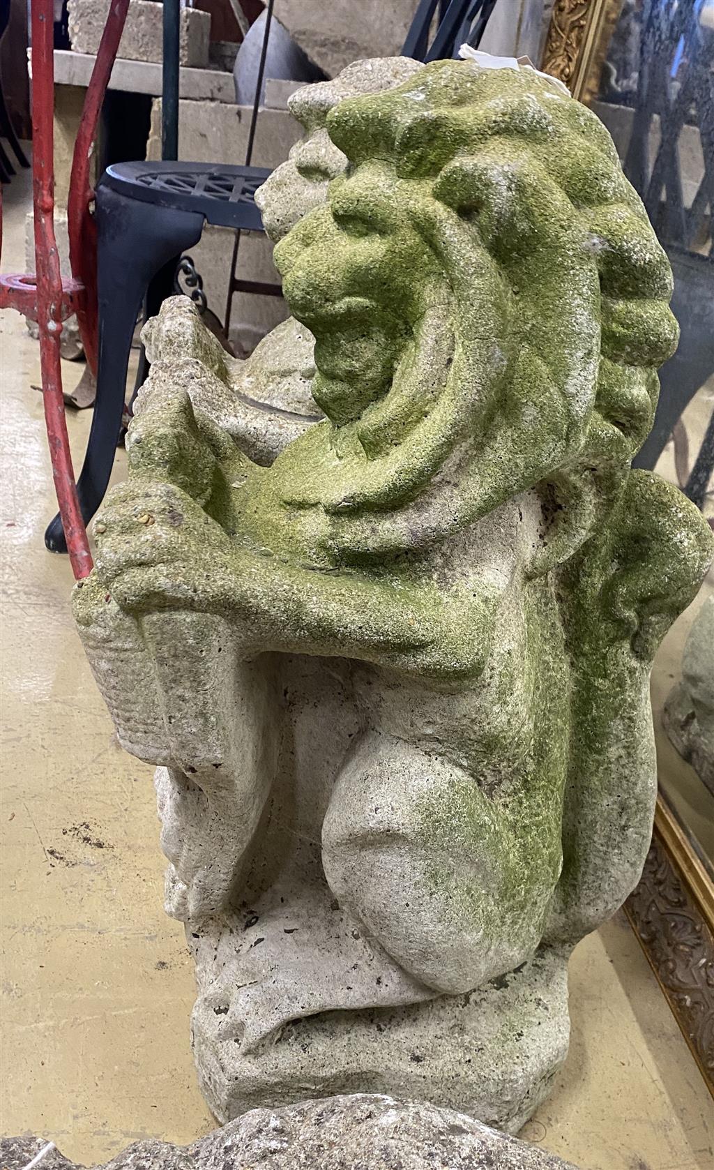 A pair of reconstituted stone lion and shield garden ornaments, height 56cm